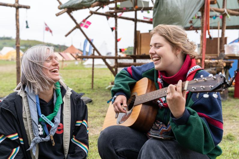 Two Scouts sing and play guitar at the Denmark Jamboree in 2023